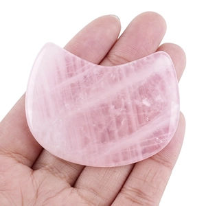 Hand-held pink rose quartz cat-shaped facial massage tool and Gua Sha stone