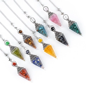Nine crystal pendulum pendants with colorful natural stones and copper coils on white background