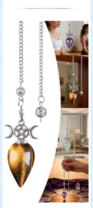Macro detail of natural stone dowsing pendulum with moon goddess and pentagram symbols