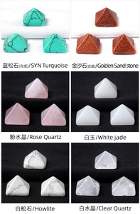 Macro detail of various natural gemstone pyramids including rose quartz and crystal