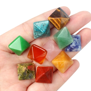 Polished natural crystal pyramid stones set held in hand featuring multiple gemstones