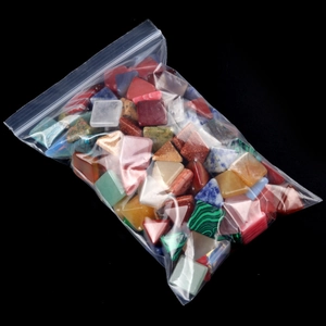 Mix of colorful geometric natural crystal pyramid stones in a bulk transparent pack