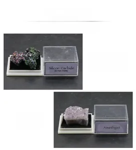 Detailed display of silicon carbide and amethyst mineral specimens in acrylic boxes
