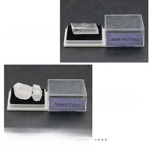 Detailed view of Calcite Rhombus and Quartz Point specimens in clear acrylic display boxes