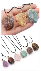 Detail view of handmade wire-wrapped crystal stone necklaces in various natural colors