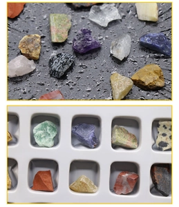 Detail view of various natural crystal mineral specimens in a white plastic sorting tray
