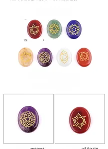 Polished oval chakra stones set with gold engraved symbols for meditation and healing yoga
