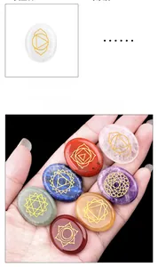Detailed view of seven chakra crystals with gold engraved symbols for energy healing