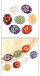 Macro view of seven chakra energy stones with engraved gold healing symbols
