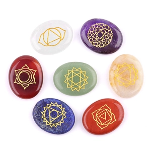 Set of 7 oval chakra stones with gold engraved symbols on polished natural crystals