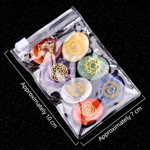 Seven chakra natural crystal oval stones set with gold symbols in a clear storage bag