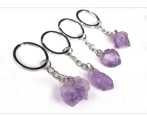 Detailed view of four raw amethyst stone keychains with natural crystal textures