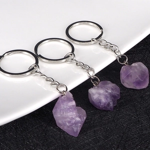 Natural amethyst raw stone keychain with silver metal ring on a black and white background