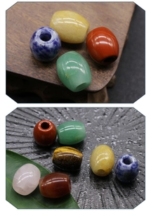 Macro detail of various colorful 16x18mm natural stone barrel beads for jewelry making