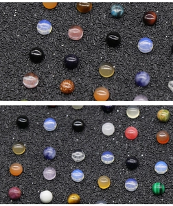 Close-up of polished multi-colored gemstone cabochons including opal and agate for DIY jewelry