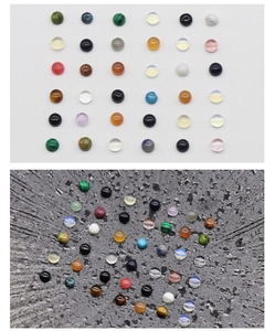 Macro detail of assorted gemstone cabochons including tiger eye and malachite for DIY jewelry