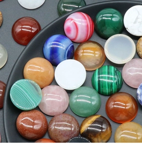 Macro detail of multi-colored round polished crystal cabochons for DIY jewelry making