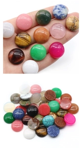Detailed view of assorted 18mm round gemstone cabochons held in hand for jewelry DIY