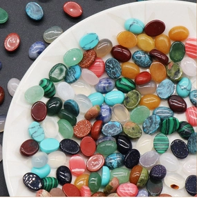 Macro detail of oval assorted natural gemstone cabochons for jewelry making