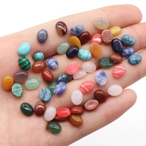 Polished oval gemstone cabochons in various colors including turquoise and rose quartz