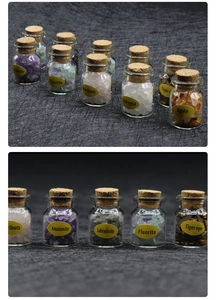 Detailed close-up of labeled mini glass bottles containing various natural crystal stones