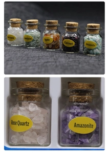 Macro shot of assorted mini crystal stone bottles with natural corks and English labels