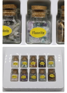 Detailed set of 10 mini glass jars containing assorted natural mineral crystal stones
