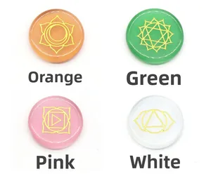 Set of four opal glass chakra discs in orange, green, pink, and white with gold symbols