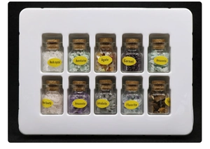 Collection of 10 natural raw gemstones in small glass bottles with cork stoppers and labels