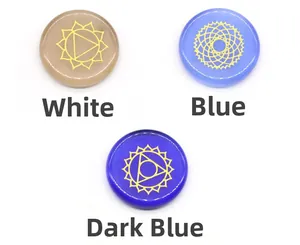 Polished opal stones with engraved golden chakra symbols in white and blue colors