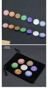 Detailed view of seven chakra healing stones with golden symbols and black velvet pouch