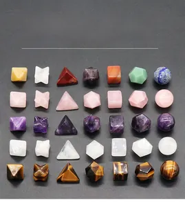 Set of seven natural gemstone geometric shapes including pyramids and crystal spheres