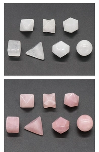 Macro detail of sacred geometry crystal sets in white and rose quartz on grey surface
