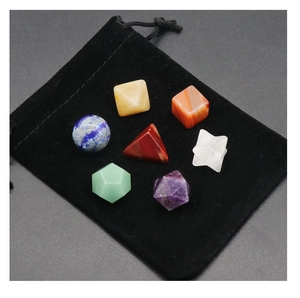 Detailed set of 7 natural crystal geometric shapes for yoga and teaching on black velvet pouch