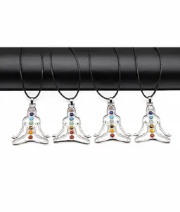 Close-up of four silver chakra yoga pendants with seven colorful energy stones on black cords
