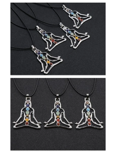 Detailed view of silver yoga meditation pendants with seven colorful chakra stones and black cords