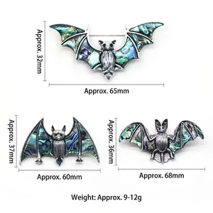 Trois broches chauve-souris vintage avec incrustations d'abalone colorées en métal argenté