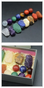 Detail of 7 chakra healing crystals with spheres and raw stones in a grey gift box