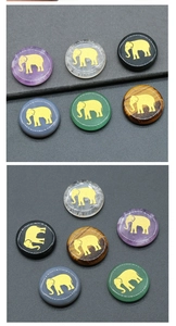 Macro view of natural crystal stones with gold elephant engraving on polished surfaces