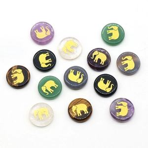 Assorted natural gemstone discs with golden elephant engravings including amethyst and quartz