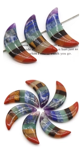 Close-up of crescent moon pendant made with seven chakra natural stone layered collage