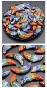 Detailed macro view of multi-color crescent moon chakra stones with polished crystal finish