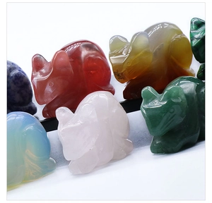 Detailed view of hand-carved mouse figurines in various natural gemstones and crystals