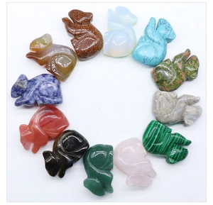 Top view of twelve carved fox figurines in assorted semi-precious stones and crystals