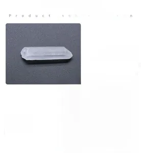 Detailed view of natural clear quartz crystal pillar and smooth polished chakra sphere