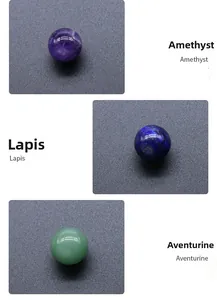 Close-up of polished Amethyst Lapis and Green Aventurine chakra crystal spheres