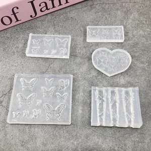 Set of 5 transparent silicone nail art molds featuring detailed 3D butterfly patterns