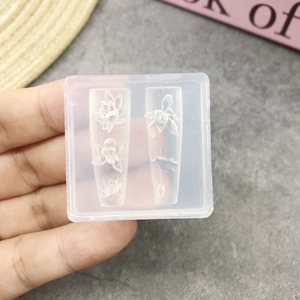 Macro view of 3D silicone nail mold featuring intricate lotus and floral relief patterns