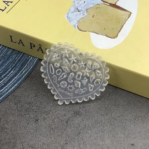 Detailed heart-shaped clear silicone nail mold with 3D ocean starfish and shell patterns