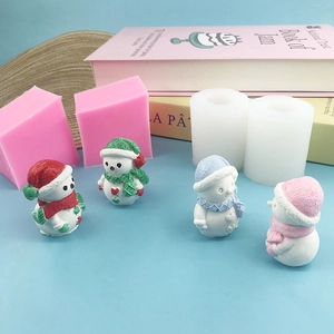 3D snowman silicone mold set for Christmas candles and gypsum crafts on a blue surface